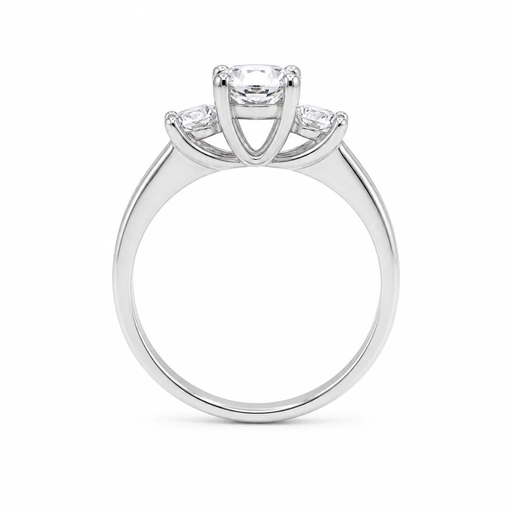 Silver ring with three diamond stones on a white background