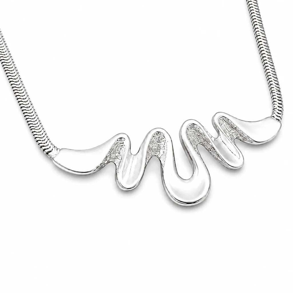 Silver necklace with a wavy pendant on a white background