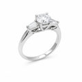 Diamond ring with two baguette diamonds on a white background