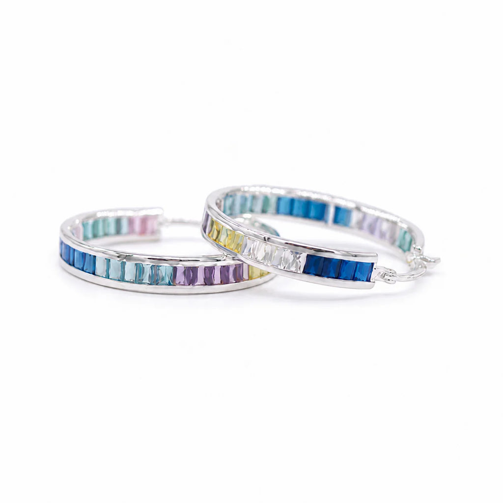Two colorful hoop earrings on a white background