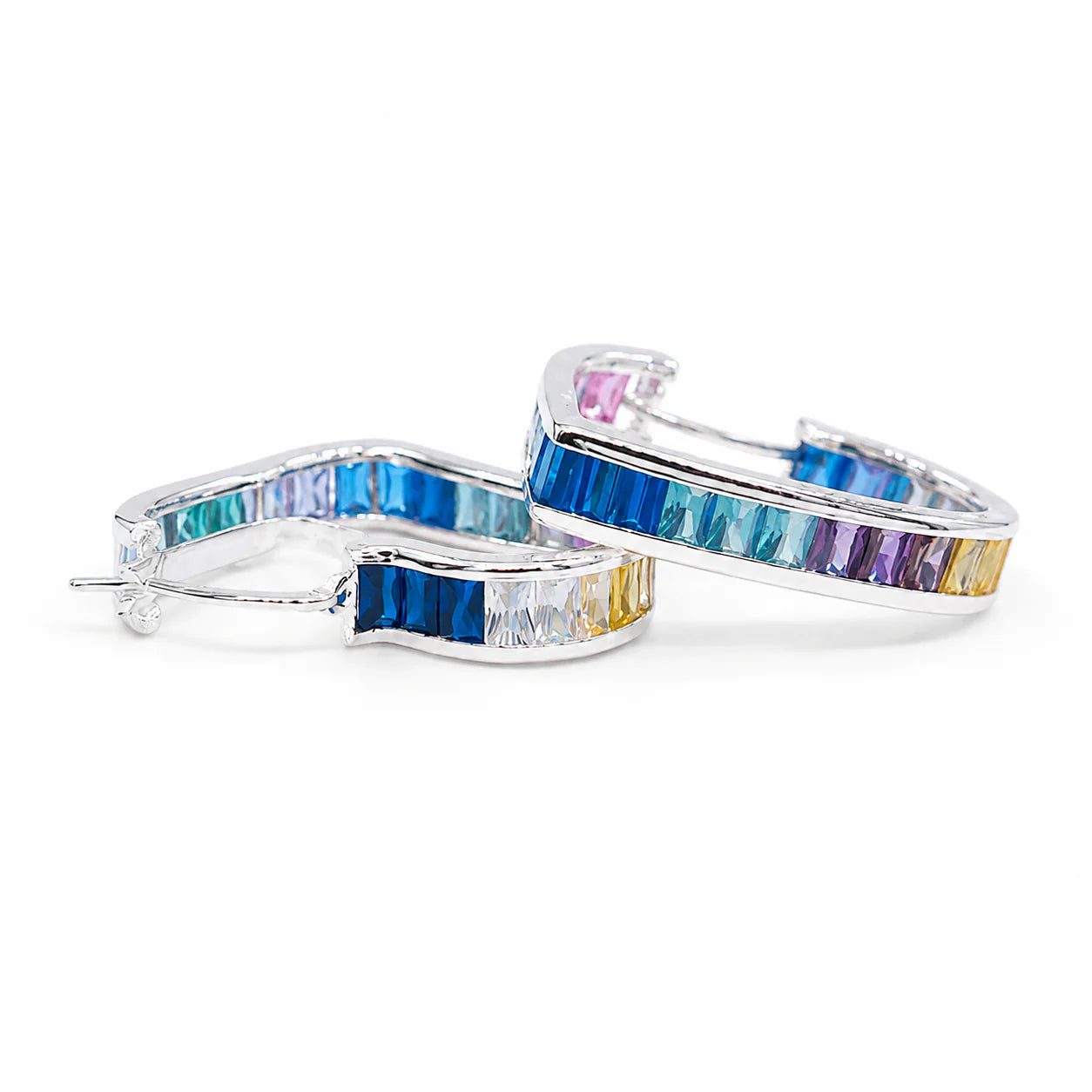 Pair of hoop earrings with multicolored gemstones on a white background