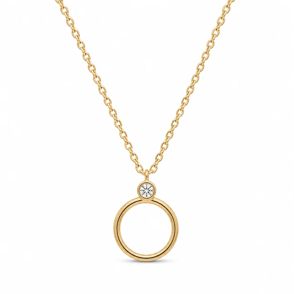 Gold necklace with a circular pendant on a white background