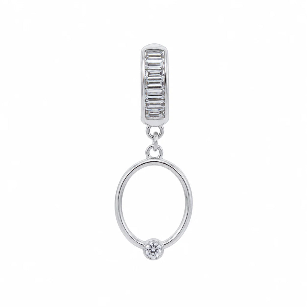 Silver earring with a round design and smaller pendant on a white background
