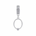 Silver earring with a round design and smaller pendant on a white background