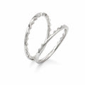 Silver ring with a textured design on a white background