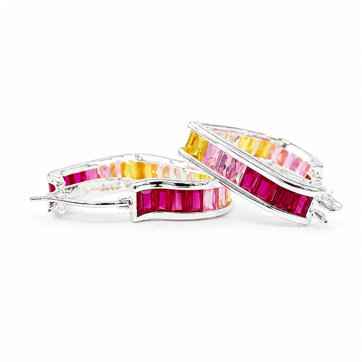 Pair of hoop earrings with colorful gemstones on a white background
