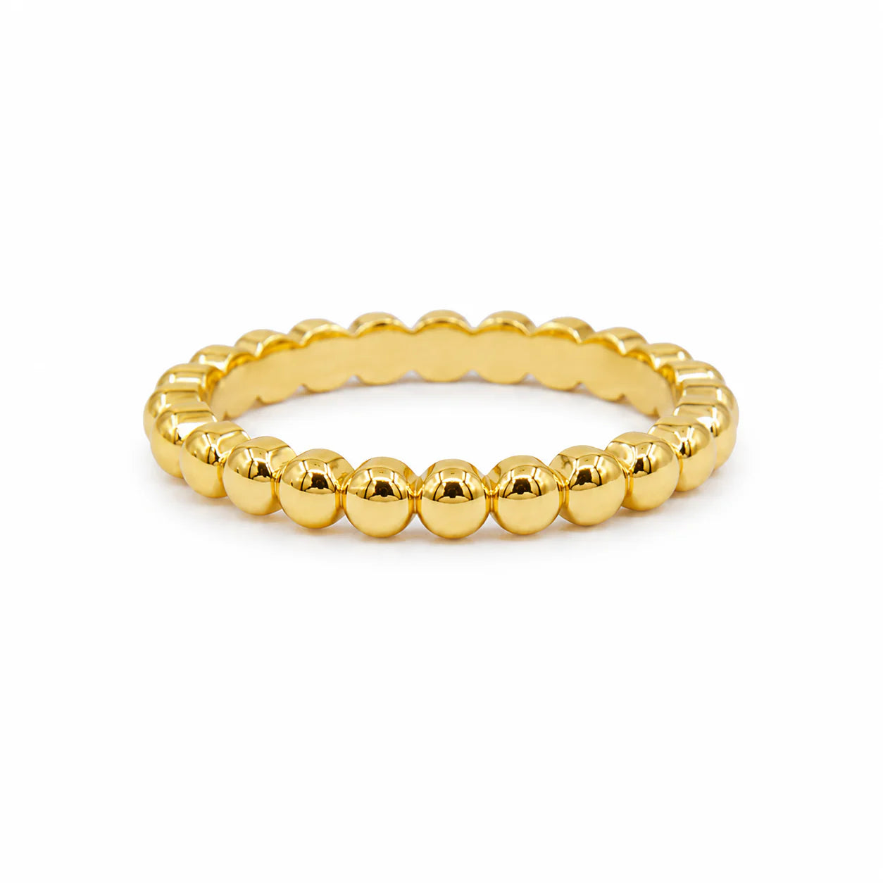 Gold beaded ring on a white background