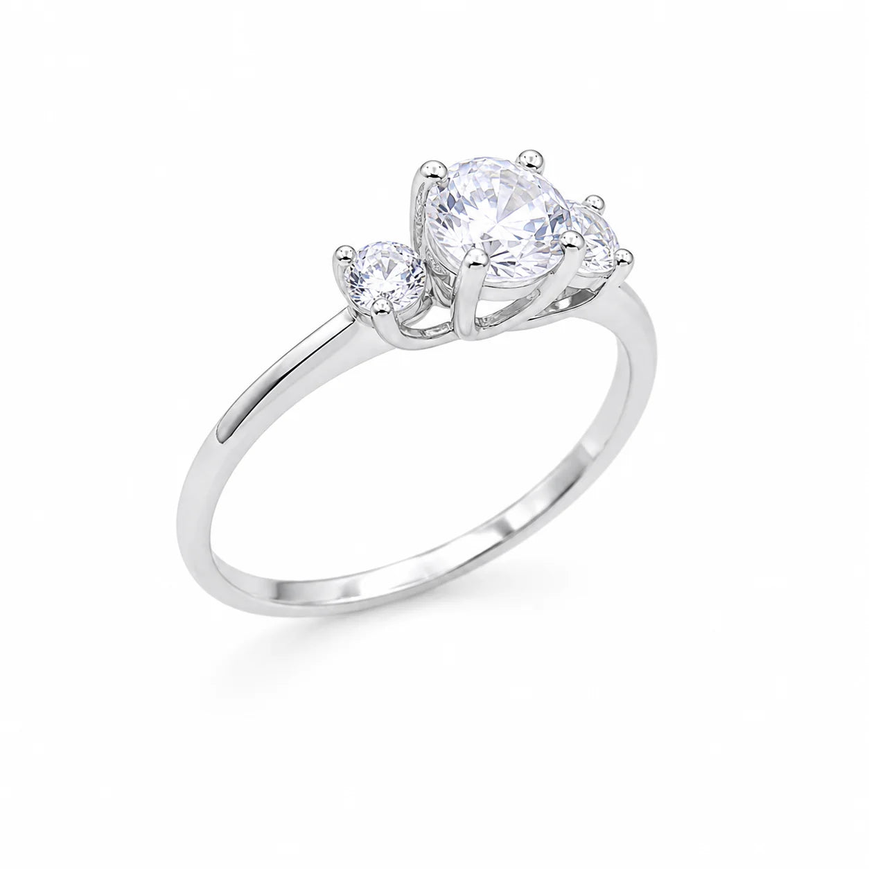 Silver ring with three clear gemstones on a white background