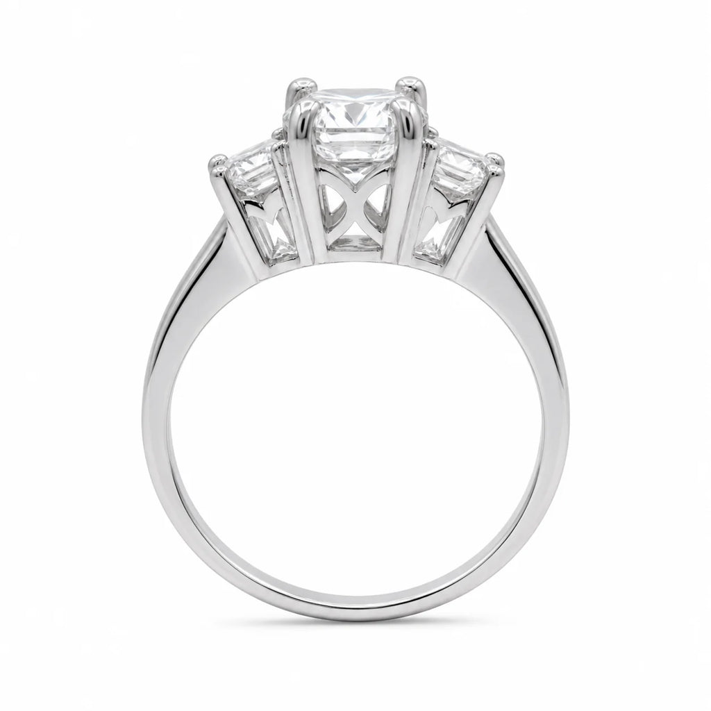 Diamond ring with three clear gemstones on a white background