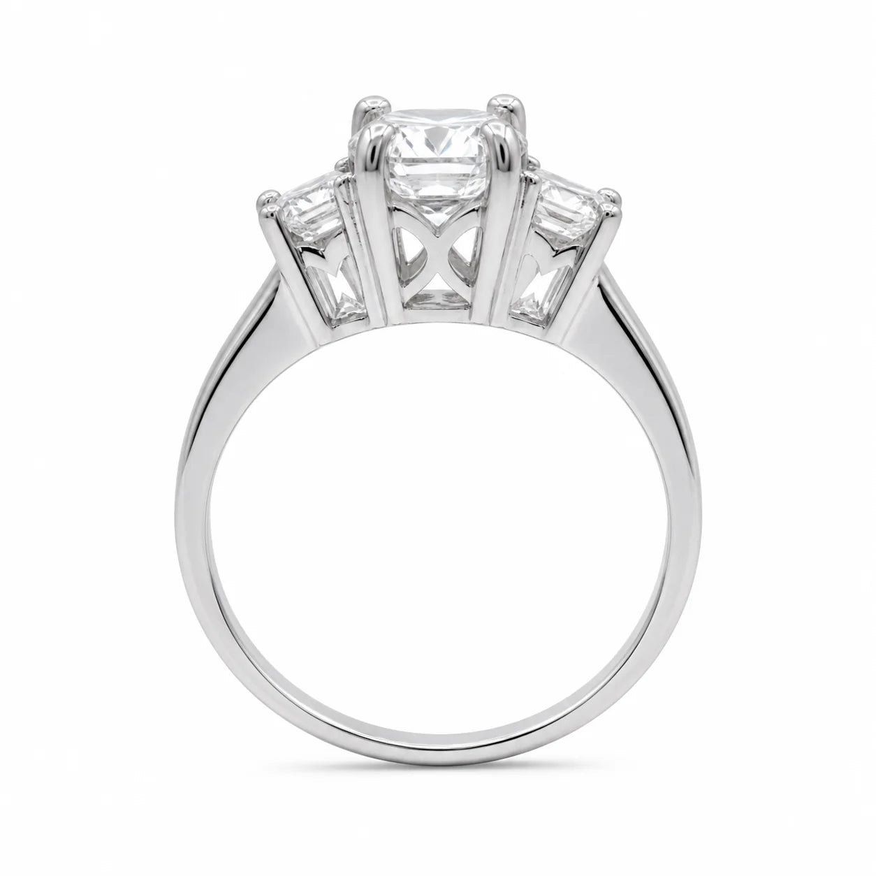Diamond ring with three clear gemstones on a white background