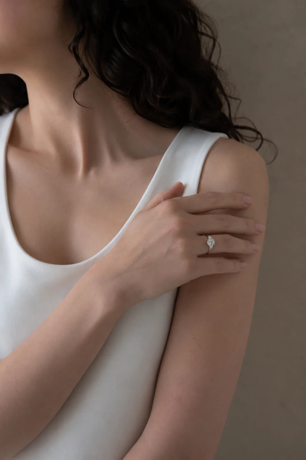 3 diamond silver ring on a woman 