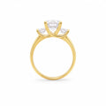 Gold ring with three diamond stones on a white background