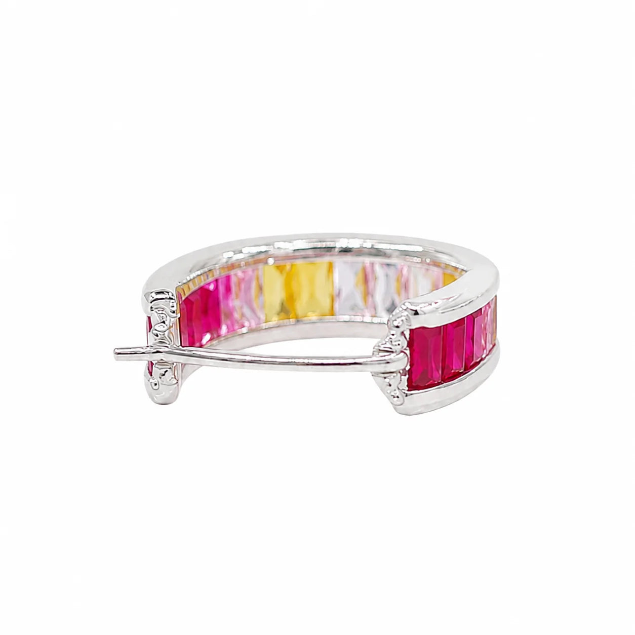 Silver ring with pink and yellow gemstones on a white background
