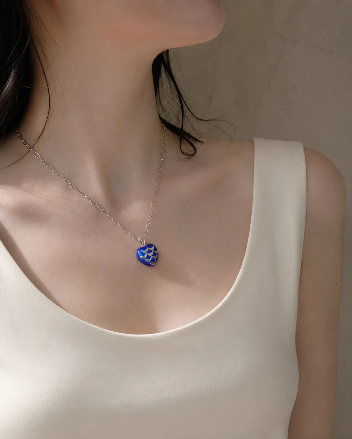 Woman wearing colorful blue pendand